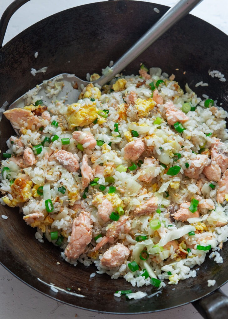 Salmon fried rice with egg garnished with green onion