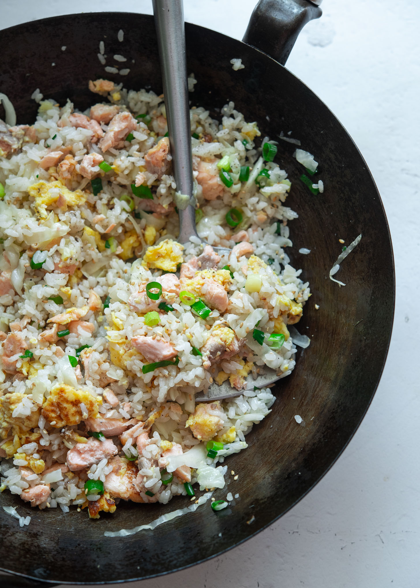 Salmon fried rice with spatula in a wok