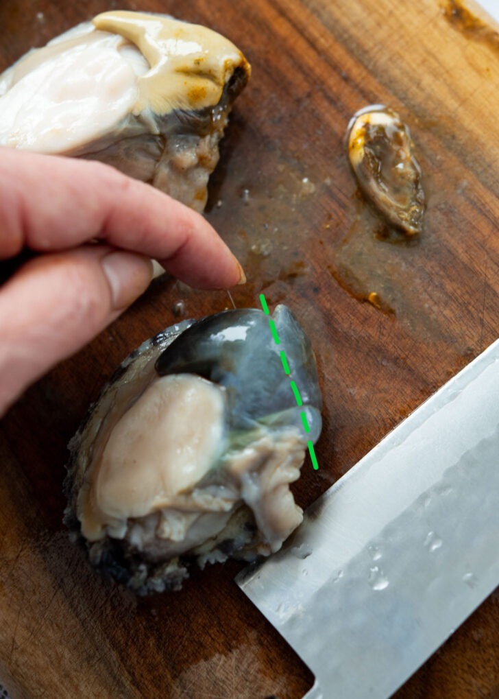 Cutting off abalone tips to remove sandy parts