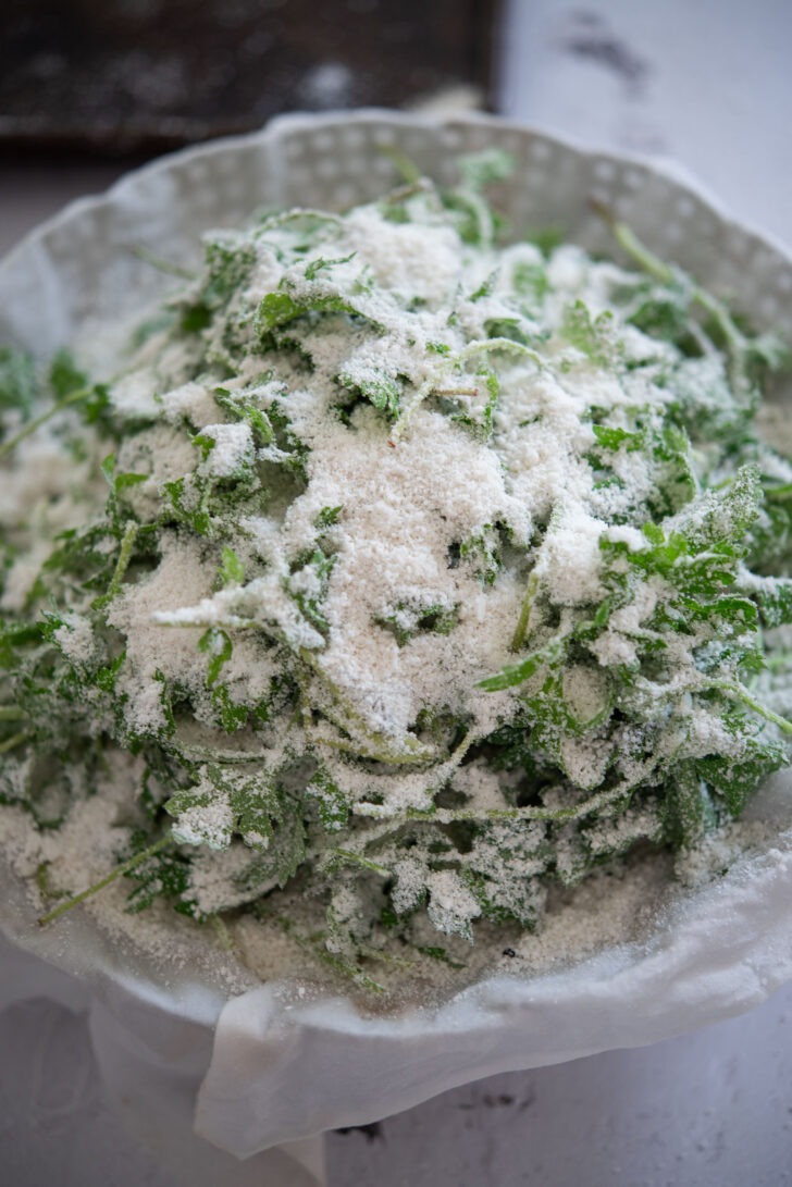 Mugwort and rice cake mixture sitting on a lined steamer