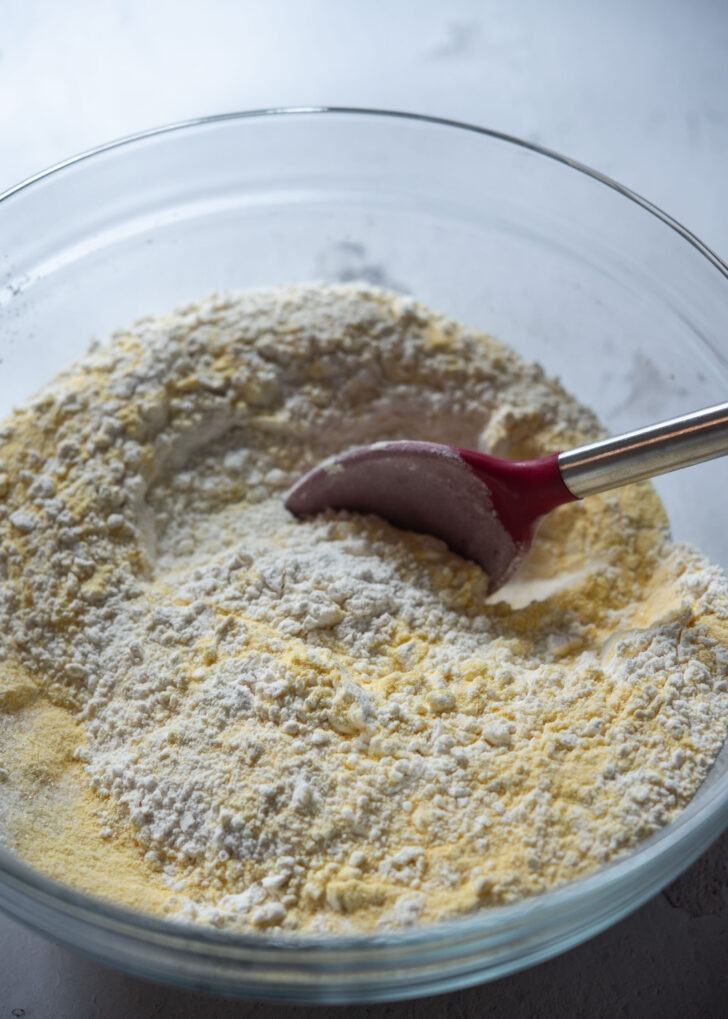 Mixing dry ingredients and fine cornmeal in a bowl