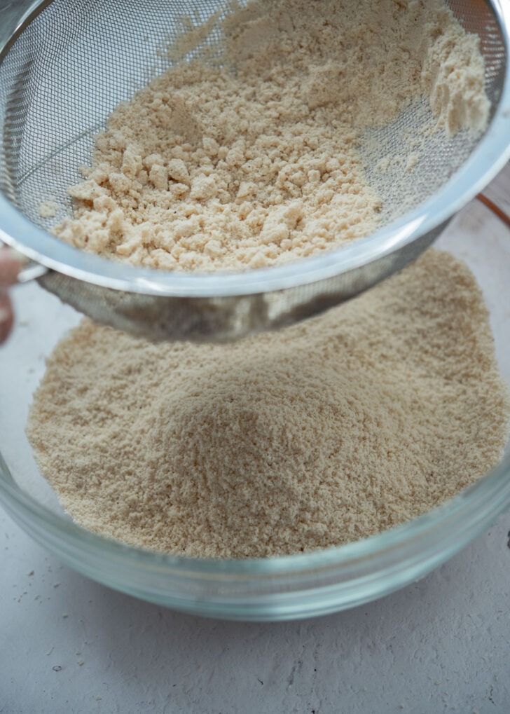 Sifting the flour and sesame oil crumbs through a sieve