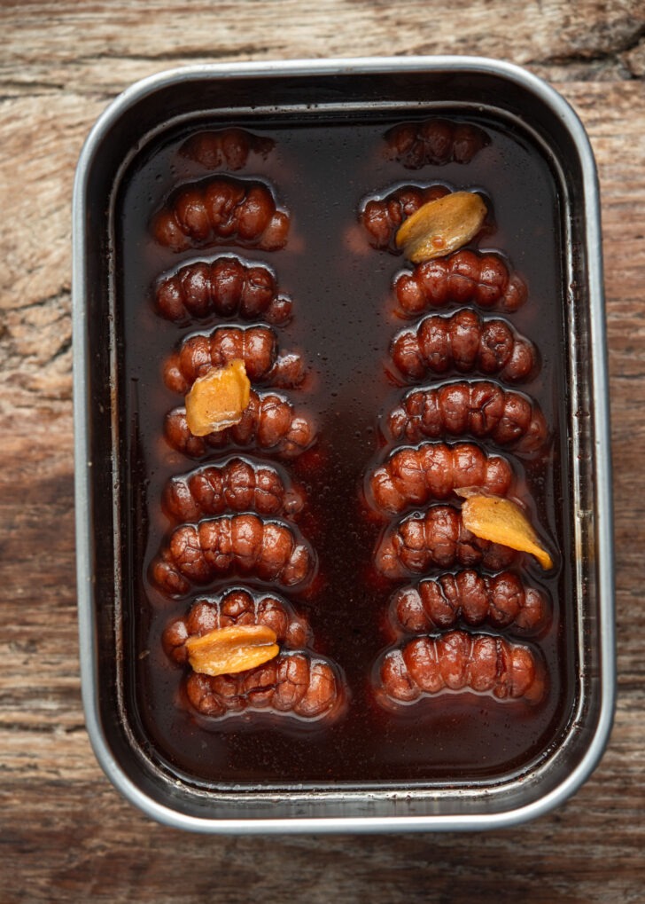 Yakgwa soaking in ginger honey syrup in a container