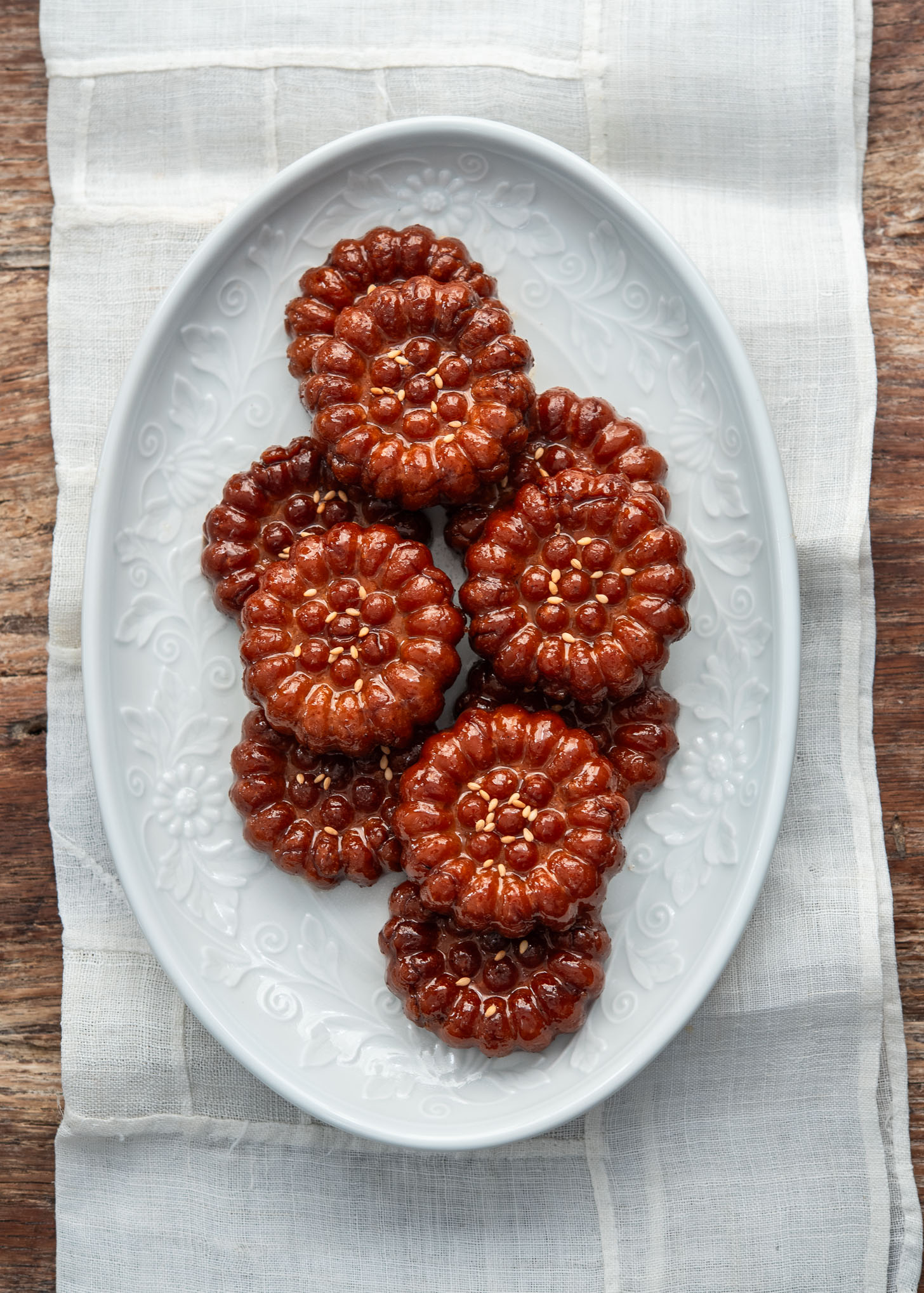 Yakgwa Korean honey cookies arranged on a white plate