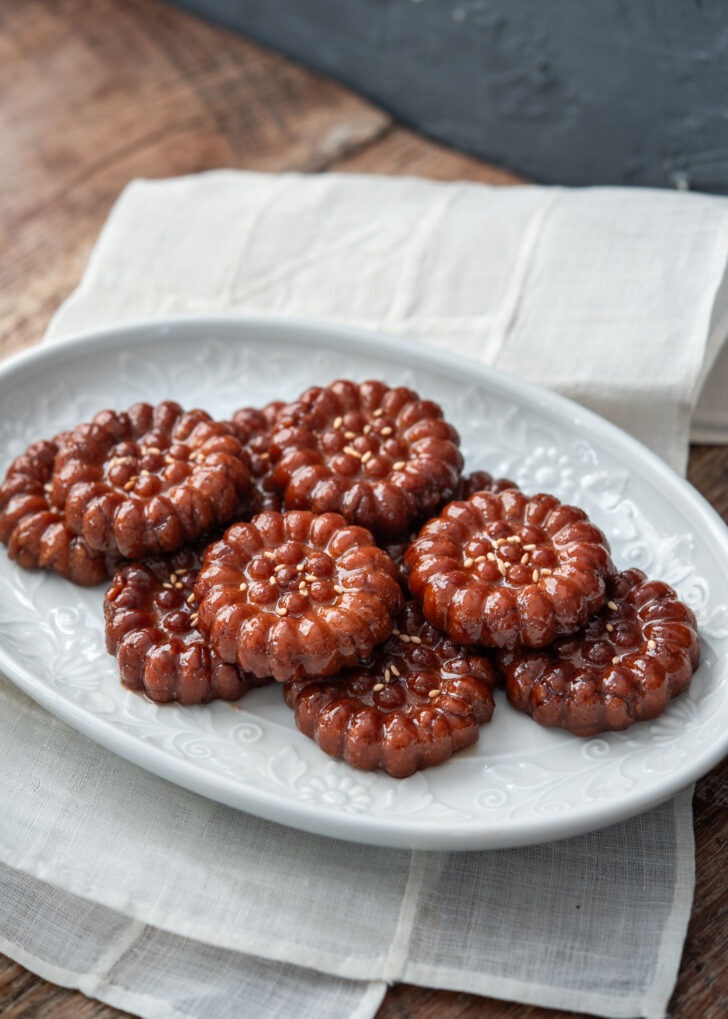 Korean honey cookies garnished with sesame seeds and plated