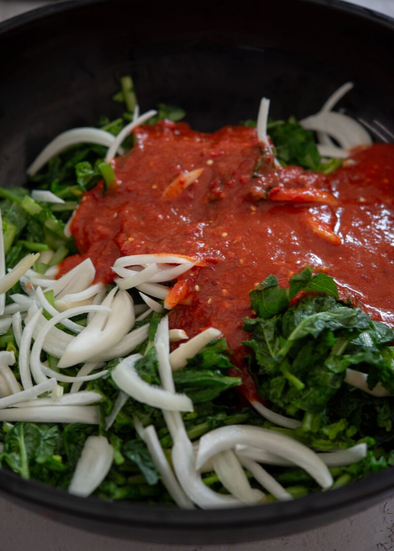 Yeolmu greens and sliced onion topped with kimchi seasoning