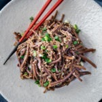gosari namul (Korean fernbrake) topped with sesame seeds and green onion