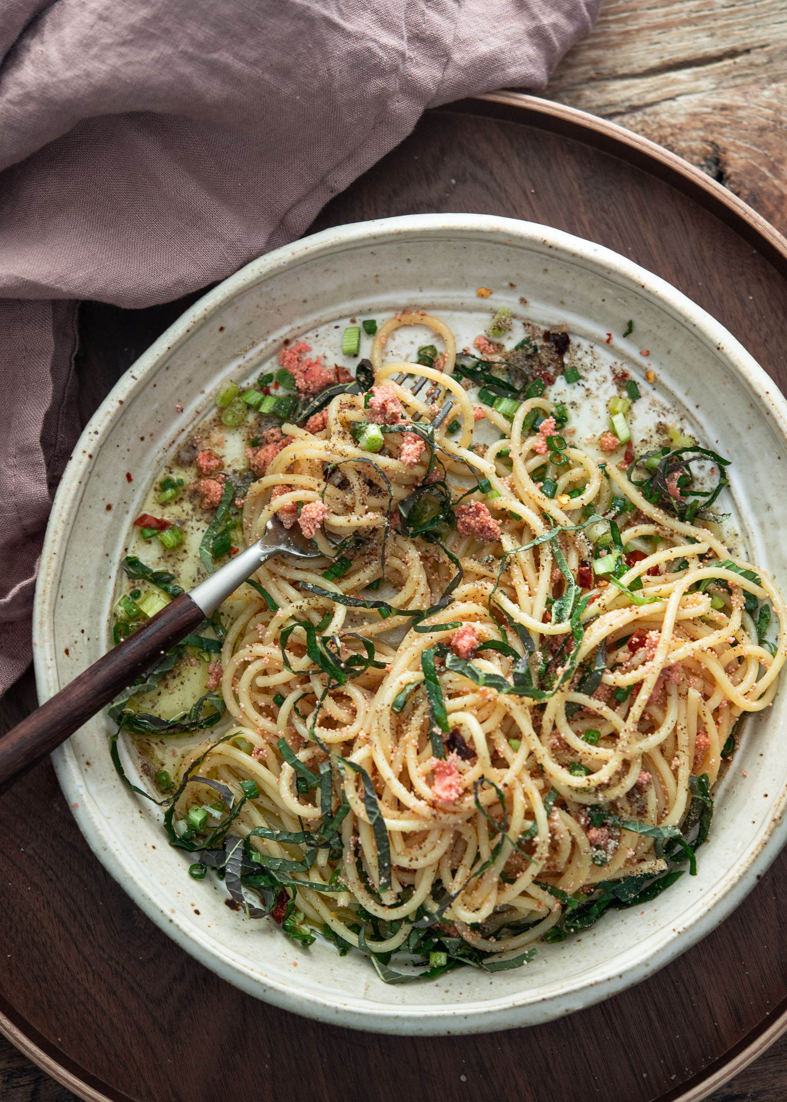 Mentaiko pasta in a bowl with garlic oil, roe, and herbs