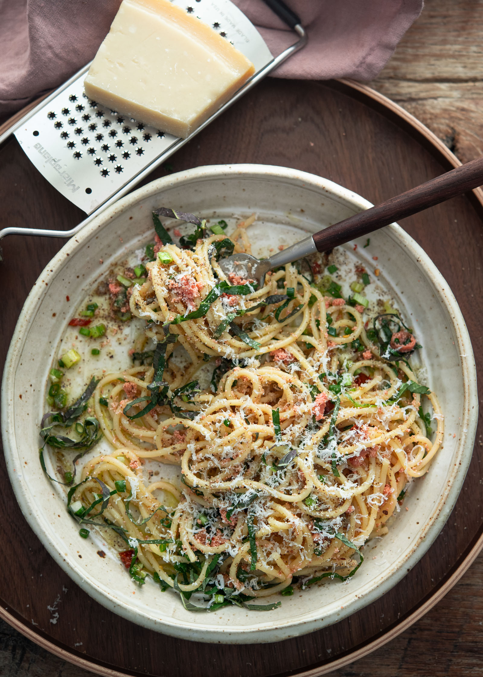 Mentaiko pasta finished with grated parmesan cheese and green onion