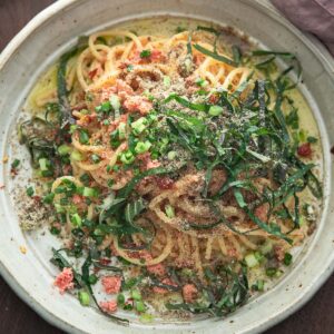 Korean-style mentaiko pasta with grated parmesan, green onion, and perilla leaves