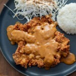 Korean donkatsu pork cutlet with brown sauce, rice, and shredded cabbage
