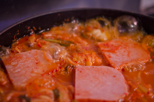 Spam kimchi stew is simmering in a pot.