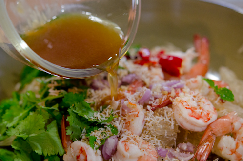 Salad dressing drizzled over pomelo and shrimp.