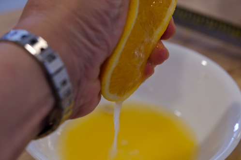 Orange juice is being squeezed out