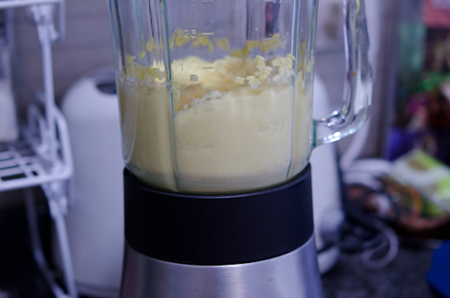 A blender is pureeing mung beans until smooth.