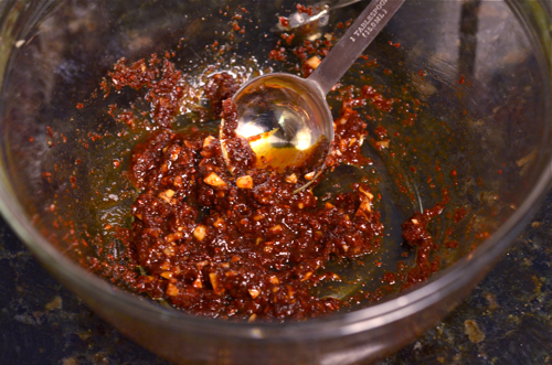 spicy sauce ingredients are mixed in a small bowl.