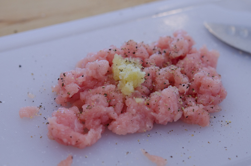 Ground pork is combined with garlic, salt and pepper.
