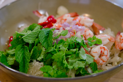 Pomelo salad ingredients combined in a bowl.