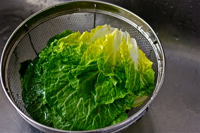 Bomdong cabbage leaves in a colander.