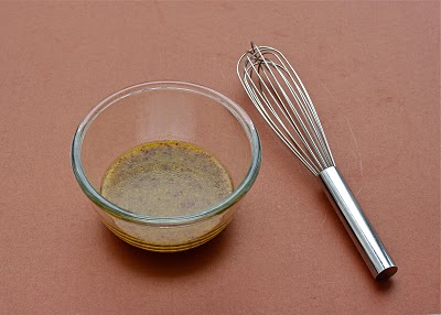 Salad dressing whisked in a bowl.